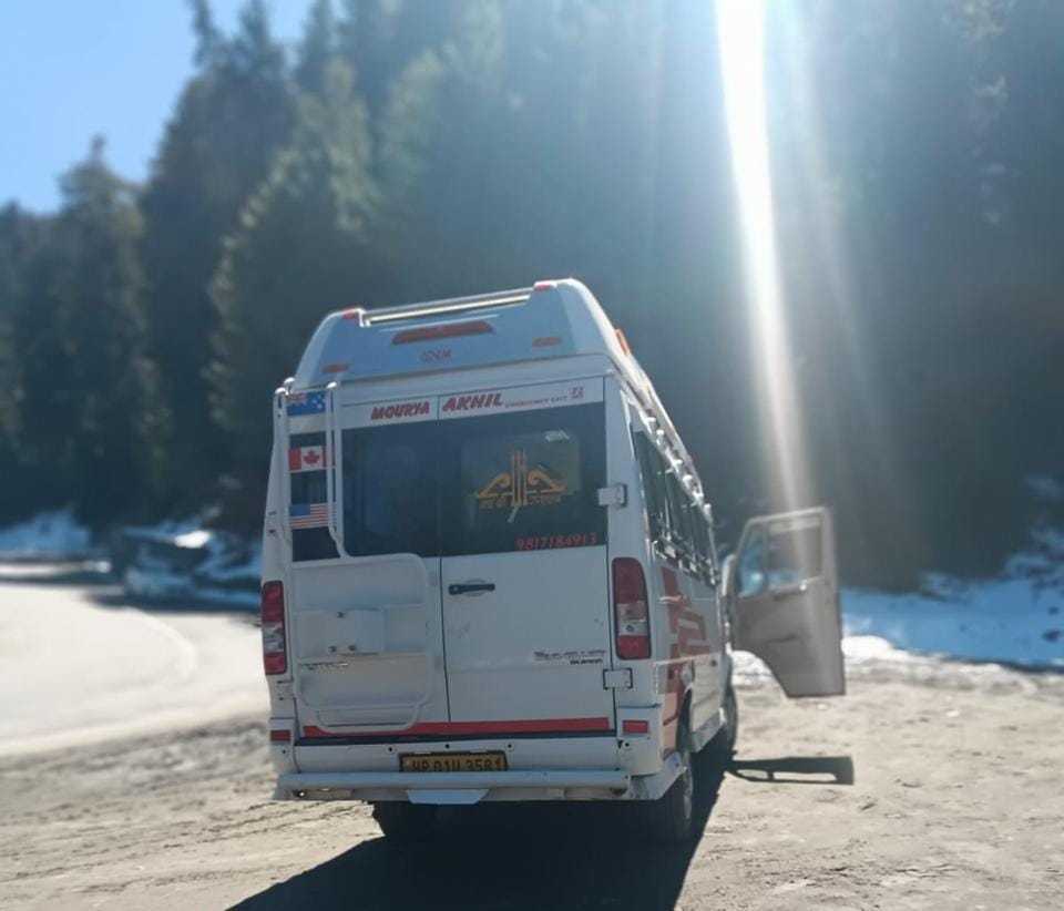 Interior of Travel With Sharma 17-seater tempo traveller - push-back seats AC music system